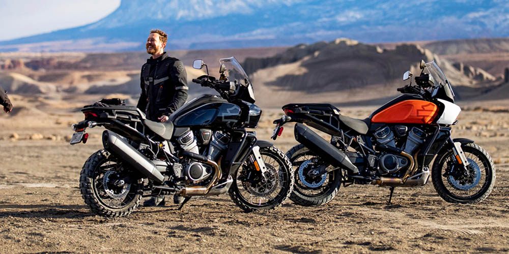 man in the desert with two harley pan americas